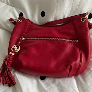 Michael Kors red purse.  bag is in great condition there are a few black mark.